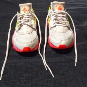 The brand is Nike the color is white, green, and pink. The size is 10